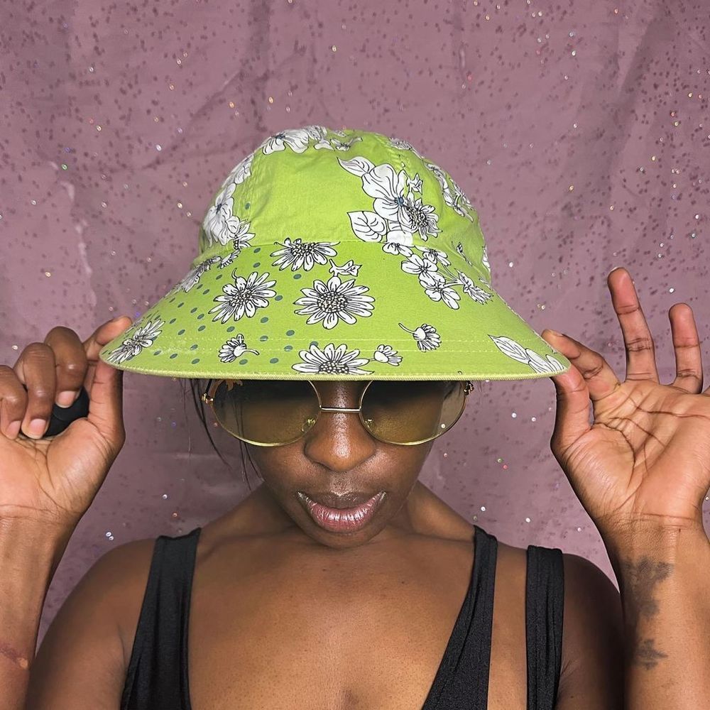 Lime green with flowers and reversible! Has a little boat on the plain side. Bet